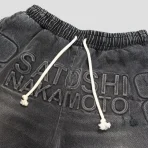 Black Denim Satoshi Nakamoto Denim Moto Shorts Close-Up View